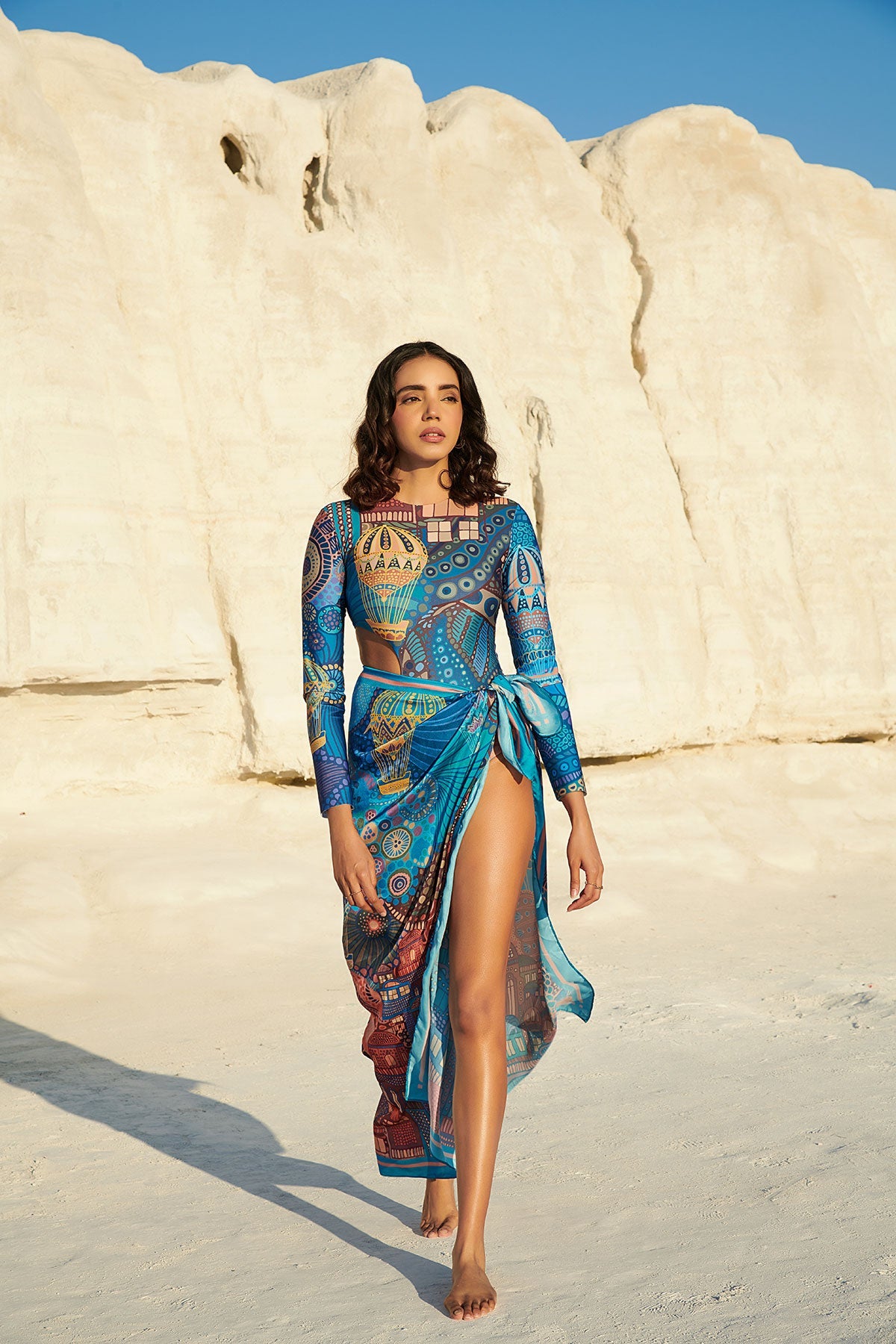 https://tizzi.in/cdn/shop/products/long-sleeved-halo-swimsuit-paired-with-beach-bum-sarong-in-cappadocia-313893.jpg?v=1698686063&width=1200